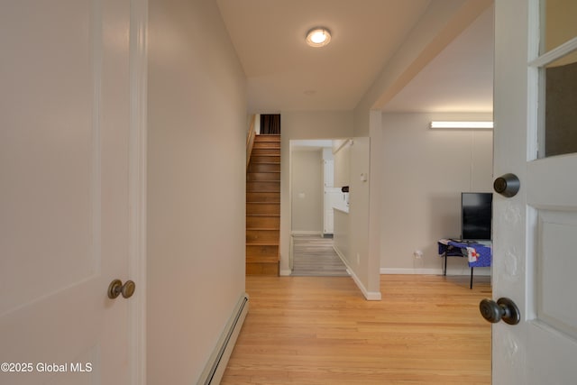 16 Van Heusen St, Colonie, NY 12205 - corridor with light wood-type flooring, baseboard heating, baseboards, and stairs