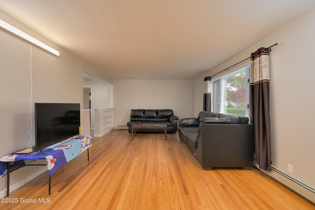 16 Van Heusen St, Colonie, NY 12205 - living room featuring light wood-style floors and baseboard heating