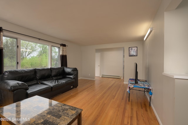 16 Van Heusen St, Colonie, NY 12205 - living room with a baseboard heating unit, light wood-style flooring, and baseboards