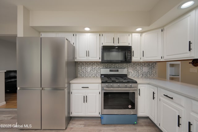 16 Van Heusen St, Colonie, NY 12205 - kitchen featuring stainless steel appliances, light countertops, white cabinets, and recessed lighting