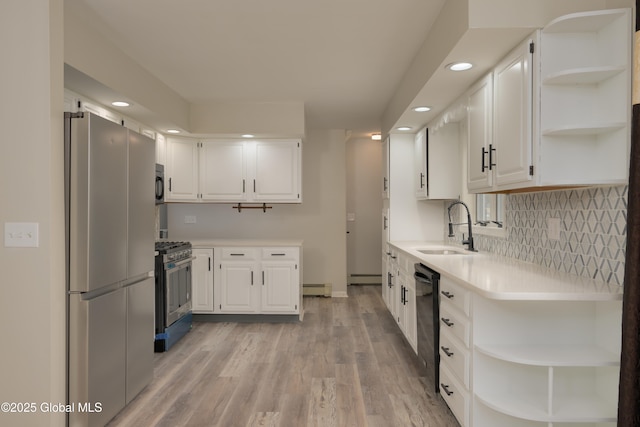 16 Van Heusen St, Colonie, NY 12205 - kitchen with open shelves, a sink, appliances with stainless steel finishes, a baseboard heating unit, and recessed lighting