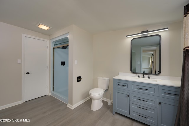 16 Van Heusen St, Colonie, NY 12205 - full bathroom featuring wood finished floors, a shower stall, toilet, vanity, and baseboards