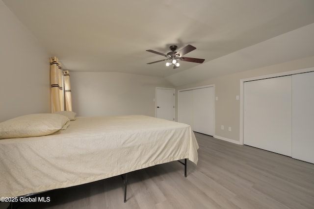 16 Van Heusen St, Colonie, NY 12205 - bedroom with multiple closets, wood finished floors, vaulted ceiling, a ceiling fan, and baseboards