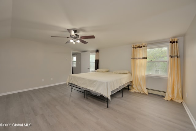 16 Van Heusen St, Colonie, NY 12205 - bedroom with a baseboard radiator, light wood finished floors, baseboards, and a ceiling fan