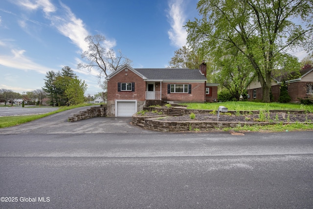 16 Van Heusen St, Colonie, NY 12205 - ranch-style home featuring driveway, a chimney, brick siding, and a garage