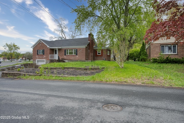 16 Van Heusen St, Colonie, NY 12205 - ranch-style house featuring brick siding, a garage, a chimney, and a front lawn