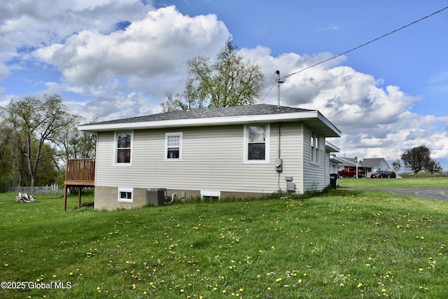 view of home's exterior with a wooden deck, a yard, and central AC unit