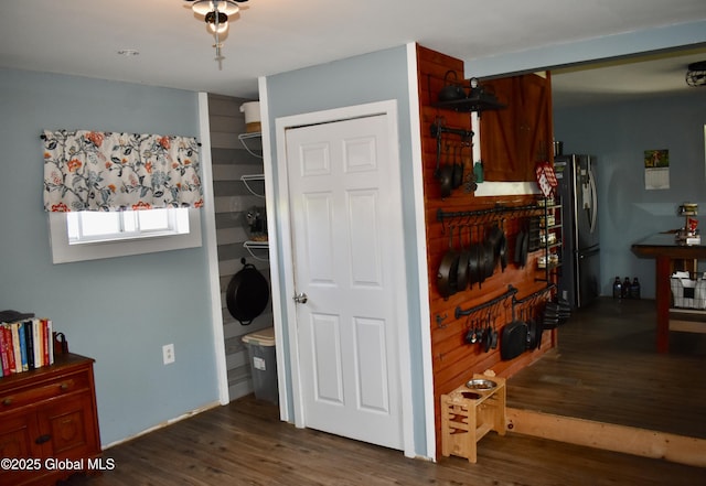interior space featuring dark wood-type flooring and freestanding refrigerator