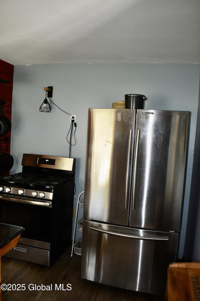 kitchen featuring stainless steel appliances and dark wood-style floors