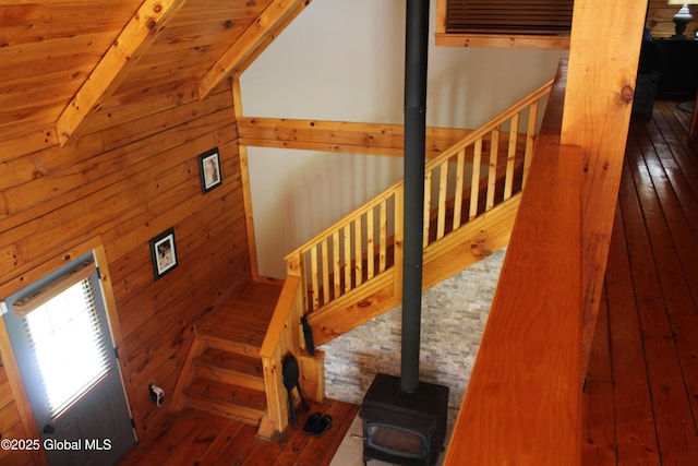 127 Fording Rd, Esperance, NY 12066 - staircase with a wood stove, beam ceiling, wooden walls, and hardwood / wood-style floors