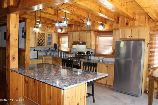 127 Fording Rd, Esperance, NY 12066 - kitchen with a kitchen breakfast bar, appliances with stainless steel finishes, beam ceiling, dark stone counters, and under cabinet range hood