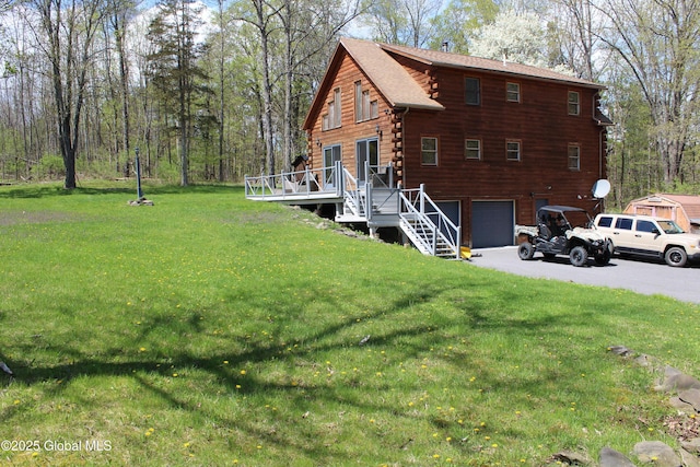 127 Fording Rd, Esperance, NY 12066 - back of house with a lawn, a garage, a wooden deck, and log siding