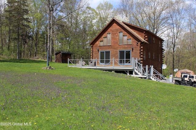 127 Fording Rd, Esperance, NY 12066 - back of property with a deck, an outbuilding, log exterior, a storage unit, and a yard