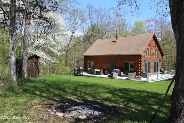 127 Fording Rd, Esperance, NY 12066 - back of house with a lawn, outdoor lounge area, roof with shingles, and log siding