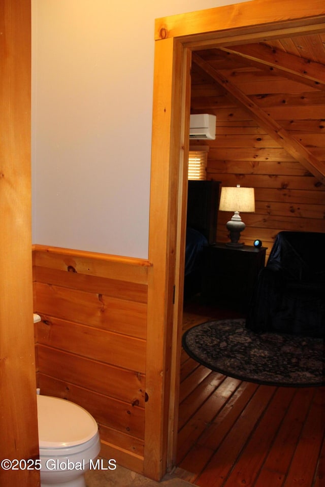 127 Fording Rd, Esperance, NY 12066 - bathroom with hardwood / wood-style flooring, toilet, wood walls, and beam ceiling