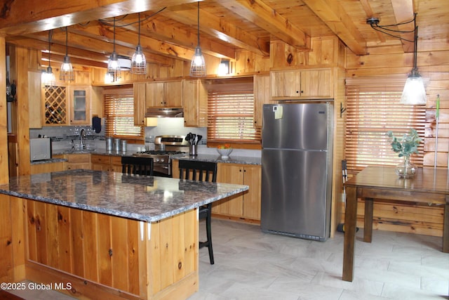 127 Fording Rd, Esperance, NY 12066 - kitchen with appliances with stainless steel finishes, tasteful backsplash, wood walls, beam ceiling, and under cabinet range hood