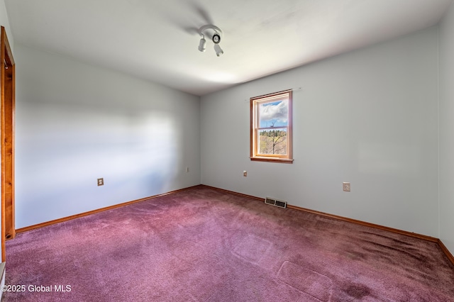 unfurnished room with baseboards, visible vents, and carpet floors