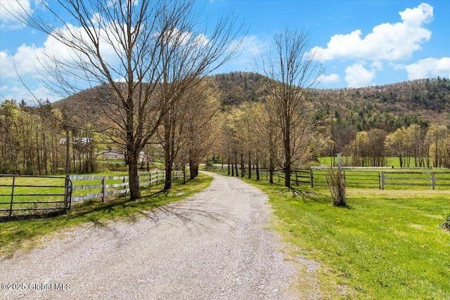 view of street featuring a forest view, a rural view, and a mountain view