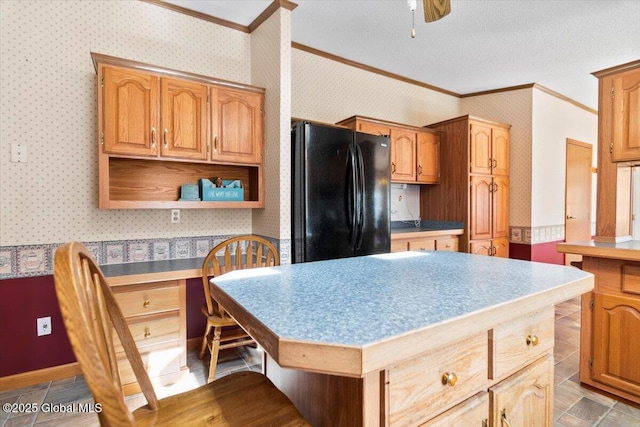 kitchen featuring ornamental molding, freestanding refrigerator, and wallpapered walls