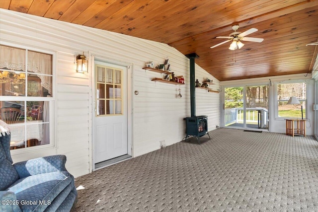 sunroom / solarium featuring a wood stove