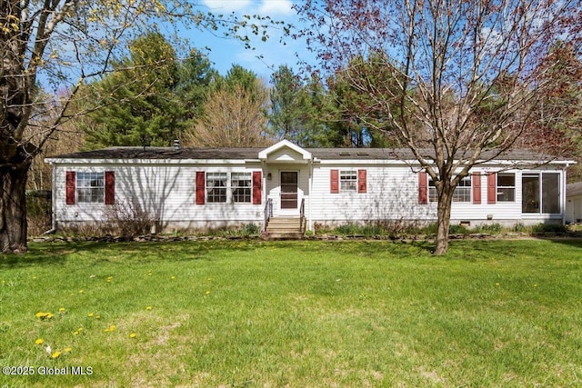 manufactured / mobile home featuring a front lawn and crawl space