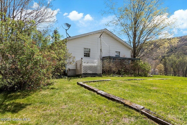 view of property exterior with a lawn