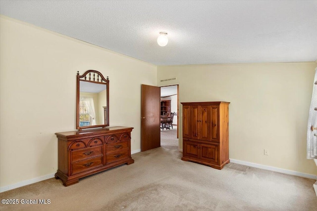 bedroom featuring baseboards, visible vents, light carpet, and lofted ceiling