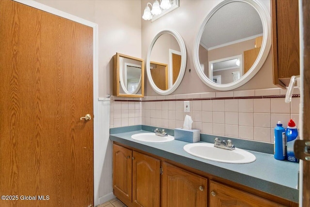 bathroom with double vanity, a sink, and ornamental molding