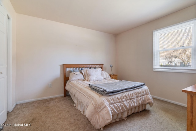 carpeted bedroom with baseboards