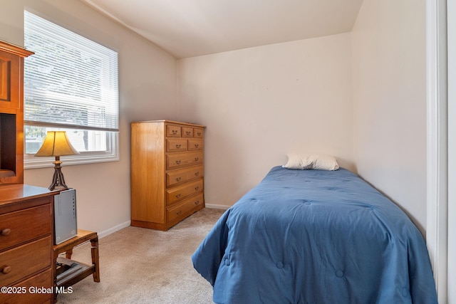 bedroom with baseboards and light carpet