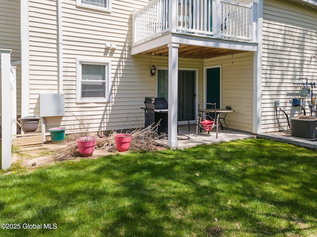 exterior space with central AC, a patio area, a yard, and a balcony