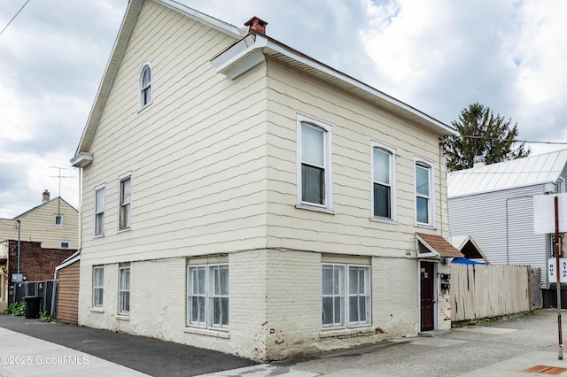 44-46 Quail St, Albany, NY 12206 - view of side of home with brick siding, fence, and a chimney