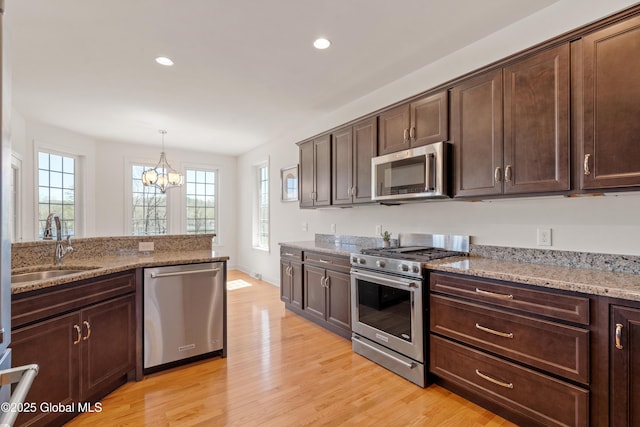 3 Riverside Ct, Stillwater, NY 12170 - kitchen featuring a sink, a notable chandelier, light wood-type flooring, and appliances with stainless steel finishes