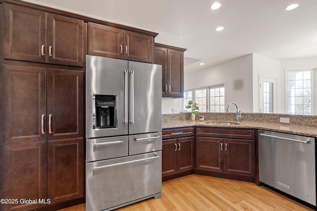 3 Riverside Ct, Stillwater, NY 12170 - kitchen featuring recessed lighting, appliances with stainless steel finishes, light stone countertops, and a sink