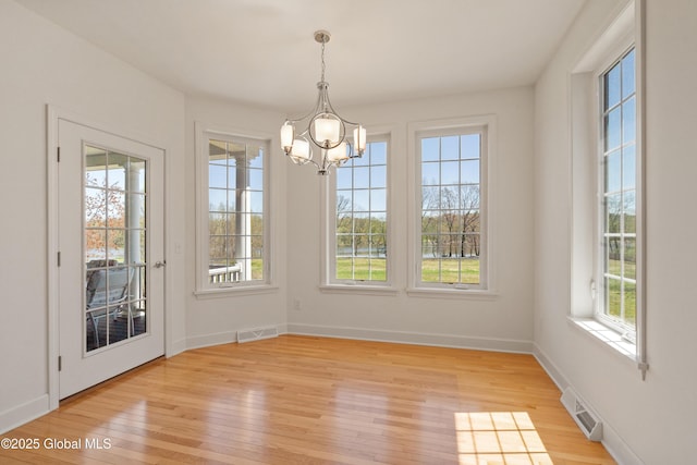 3 Riverside Ct, Stillwater, NY 12170 - unfurnished dining area featuring a wealth of natural light, an inviting chandelier, and light wood-style flooring