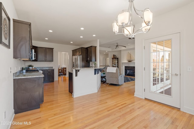 3 Riverside Ct, Stillwater, NY 12170 - kitchen featuring a breakfast bar, dark brown cabinetry, stainless steel appliances, and light wood-type flooring