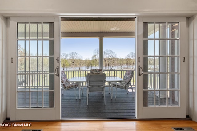3 Riverside Ct, Stillwater, NY 12170 - doorway to outside with a water view, a healthy amount of sunlight, and wood finished floors