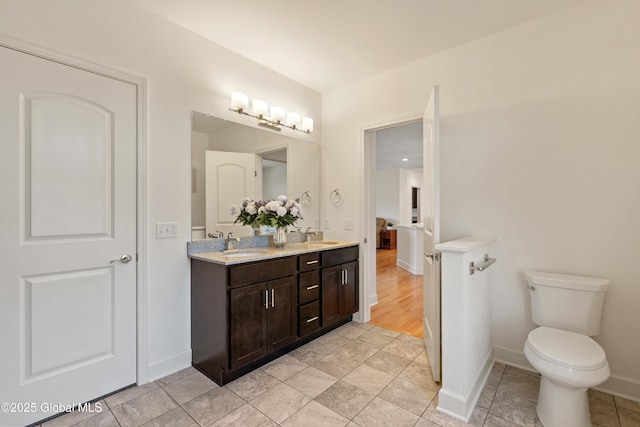 3 Riverside Ct, Stillwater, NY 12170 - full bathroom with double vanity, toilet, a sink, baseboards, and tile patterned flooring