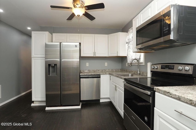 kitchen with appliances with stainless steel finishes, a sink, a ceiling fan, white cabinetry, and recessed lighting