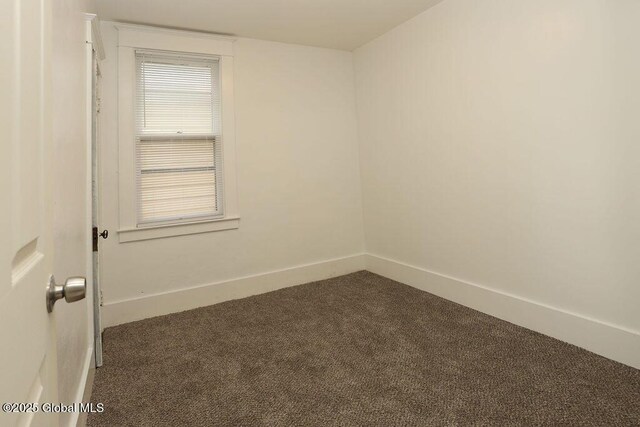 carpeted empty room with baseboards