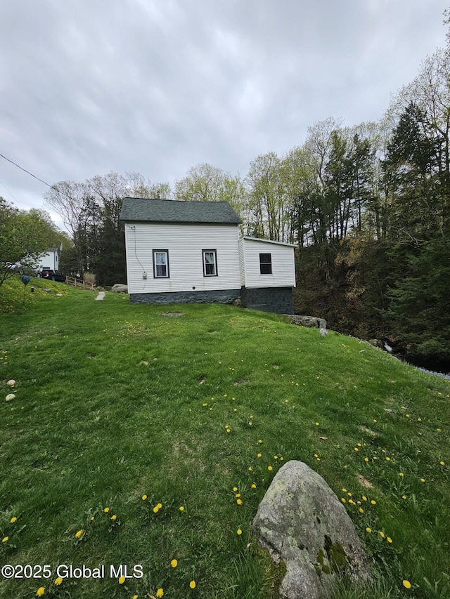 back of property featuring a yard