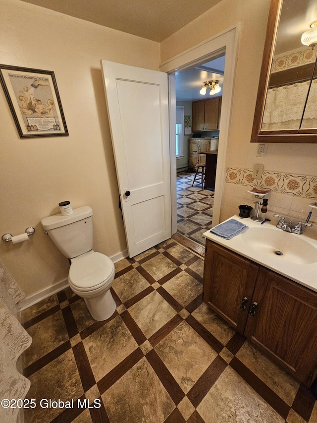 bathroom featuring toilet and vanity