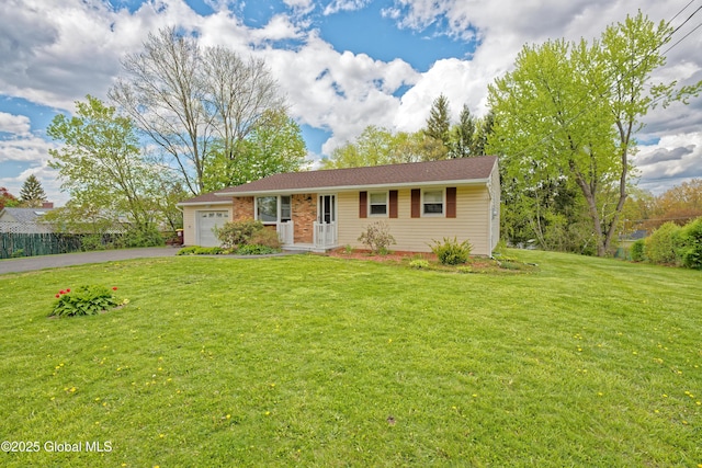 ranch-style house with an attached garage, driveway, and a front yard