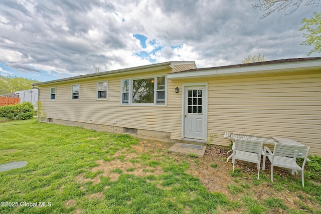 back of property featuring a yard