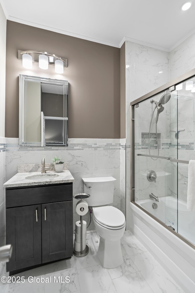 bathroom featuring toilet, tile walls, ornamental molding, and shower / bath combination with glass door