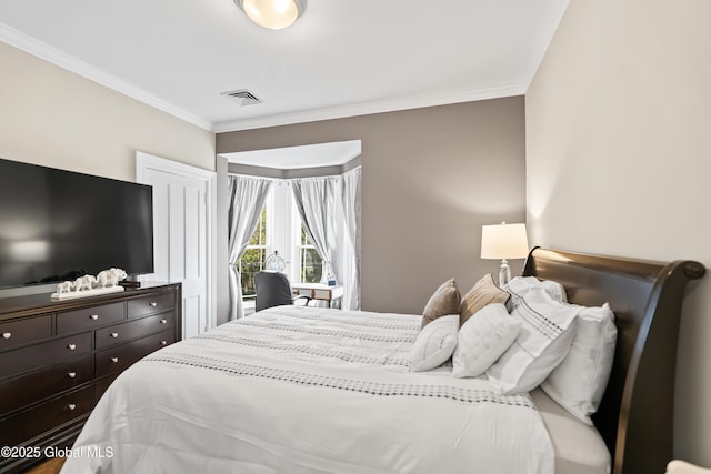 bedroom featuring ornamental molding and visible vents