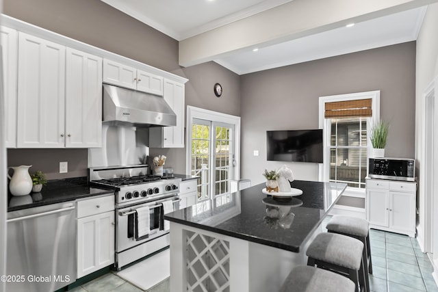 kitchen featuring stainless steel appliances, under cabinet range hood, crown molding, light tile patterned floors, and white cabinets