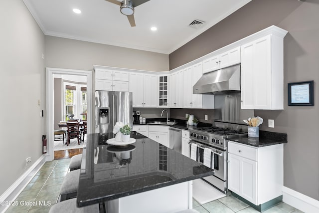 kitchen with under cabinet range hood, ornamental molding, visible vents, a sink, and appliances with stainless steel finishes