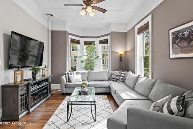 living area with a ceiling fan, baseboards, dark wood finished floors, and visible vents