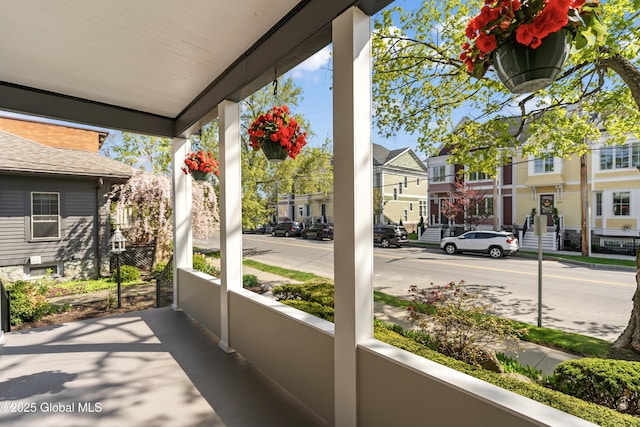view of patio with covered porch and a residential view